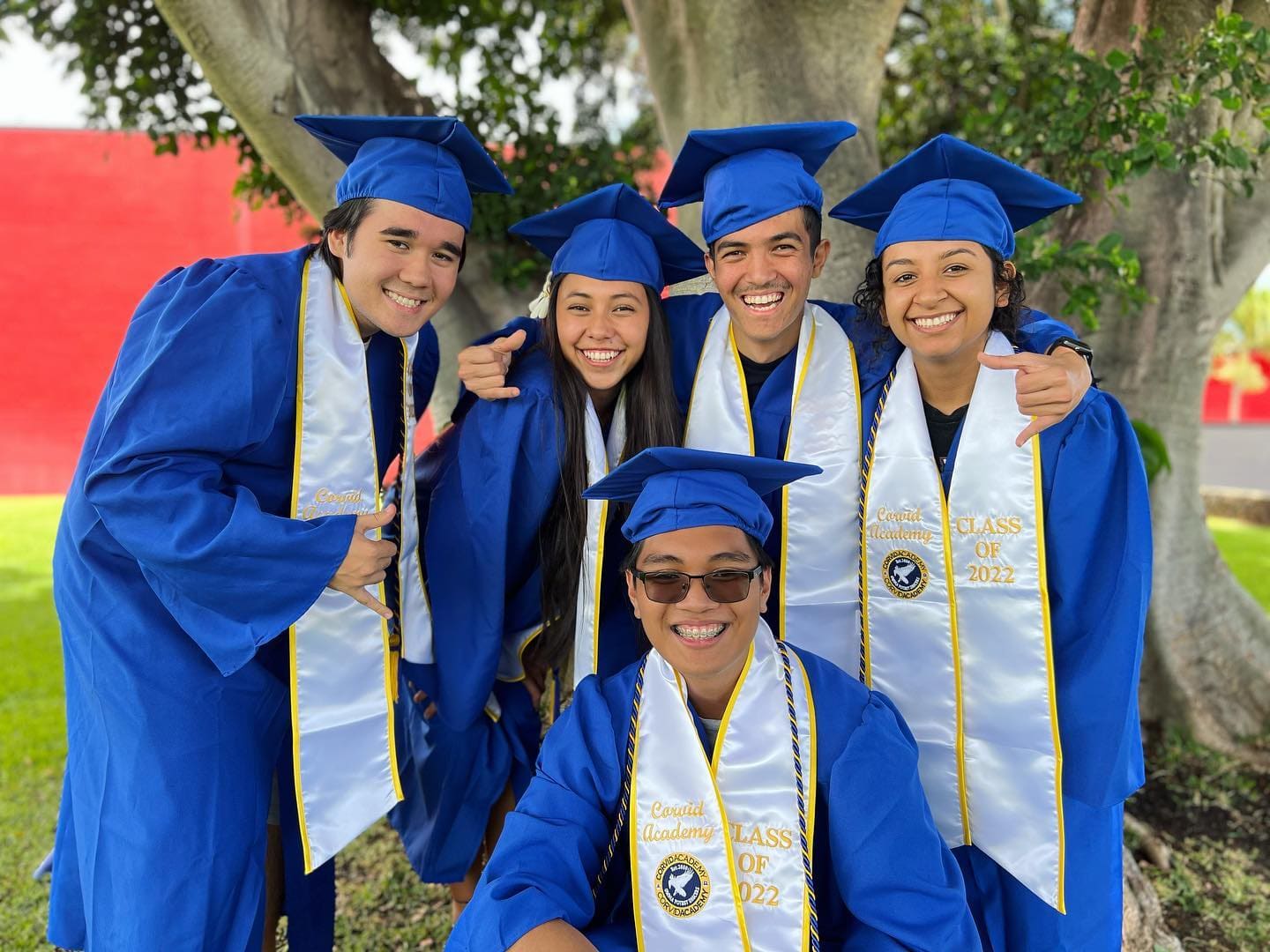 Smiling Kapolei Christian Academy graduates in cap and gown on graduation day.